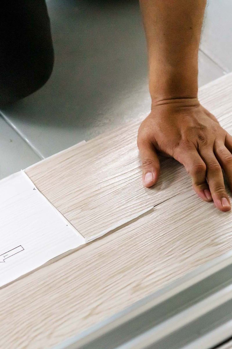 man-installing-a-vinyl-floor-self-adhesive-vinyl-WW3PGBZ.jpg